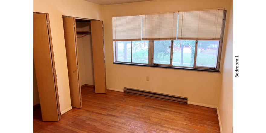 Unfurnished bedroom with hardwood floor
