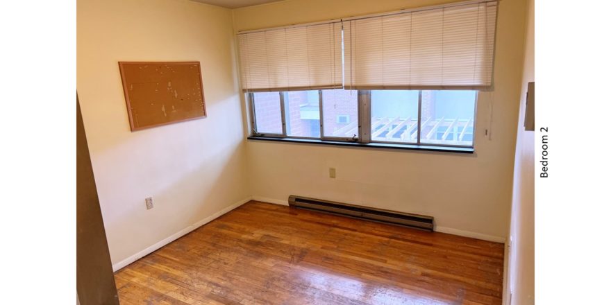 Unfurnished bedroom with hardwood floor