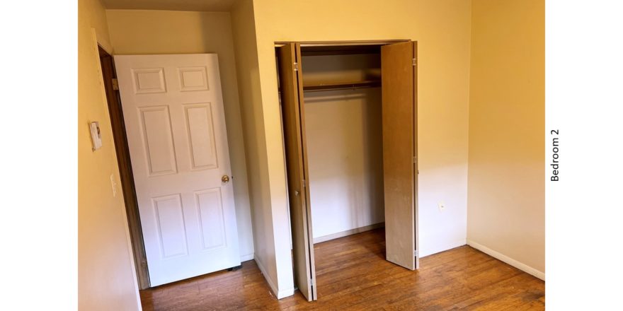 Unfurnished bedroom with hardwood floor