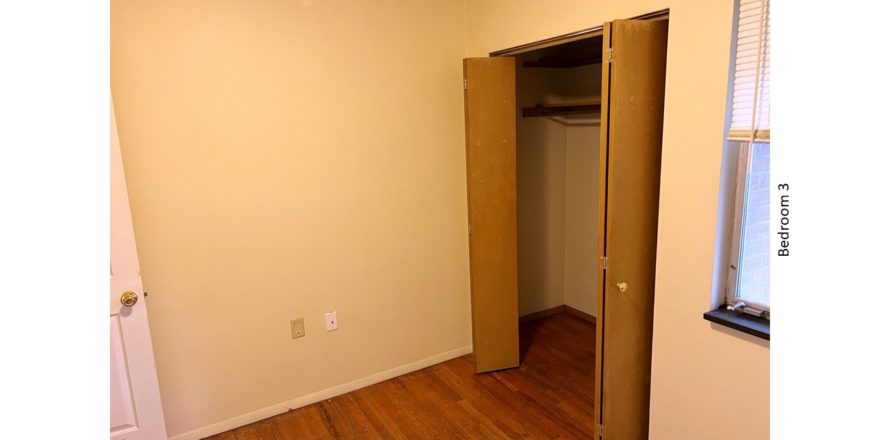 Unfurnished bedroom with hardwood floor