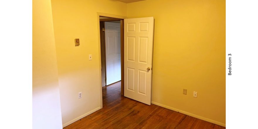 Unfurnished bedroom with hardwood floor