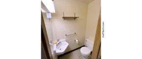 Half bathroom with wall-mounted sink and toilet