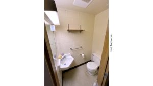 Half bathroom with wall-mounted sink and toilet