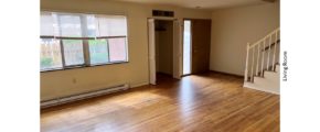 Unfurnished living room with closet and hardwood floor