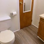 Bathroom with toilet, closet, and vanity