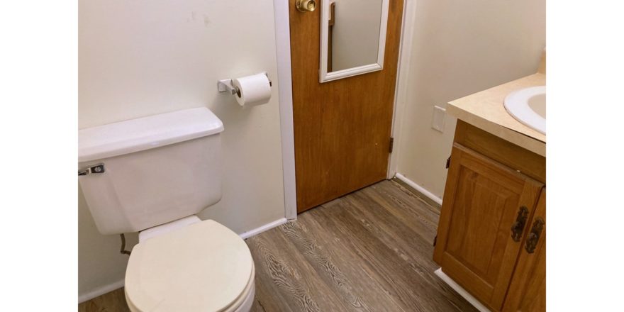 Bathroom with toilet, closet, and vanity