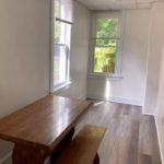 Bedroom with large windows and desk
