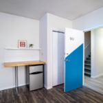 Room with shelf and decorations, countertop, and mini-fridge