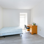 Room with bed, desk, chair and window
