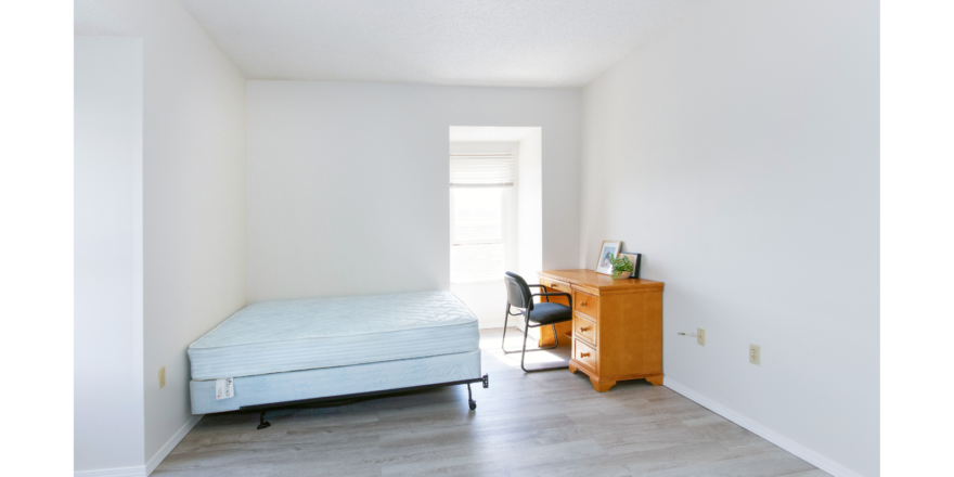 Room with bed, desk, chair and window