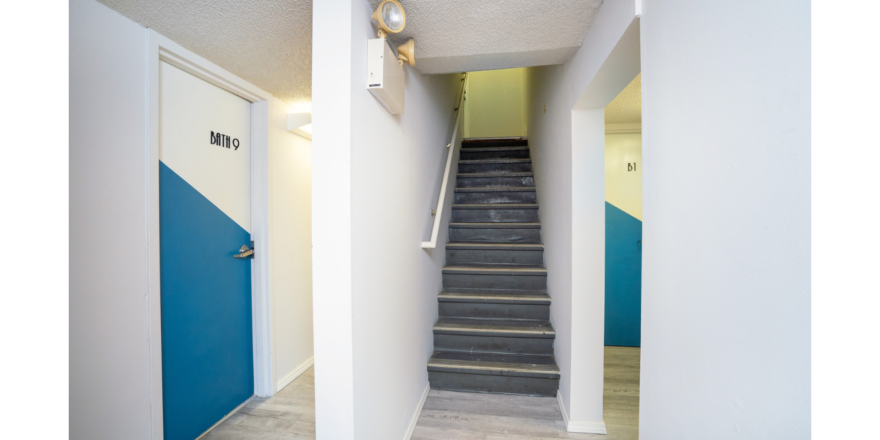 Hallway with stairway and doors