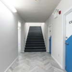 Hallway with stairway and doors