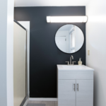 Bathroom with vanity, mirror, and shower stall