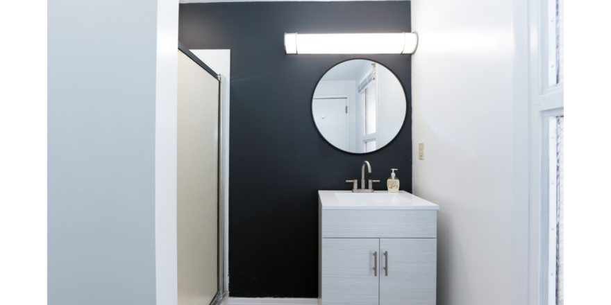 Bathroom with vanity, mirror, and shower stall