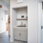 Hallway with sink and shelf
