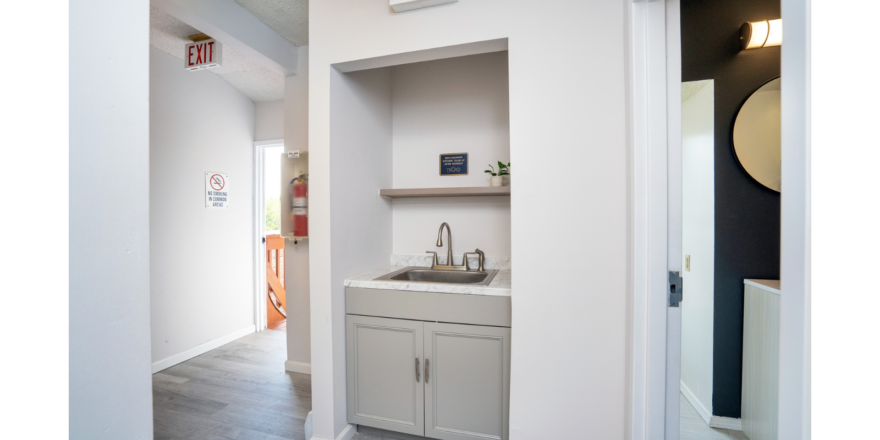 Hallway with sink and shelf