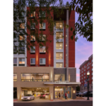 Nighttime exterior photo of apartment building Pugh Centre