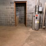 Unfinished basement with sink and water heater