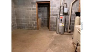 Unfinished basement with sink and water heater