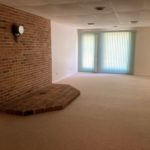 Den with brick hearth and drop ceiling
