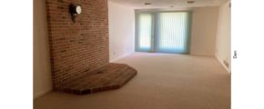 Den with brick hearth and drop ceiling
