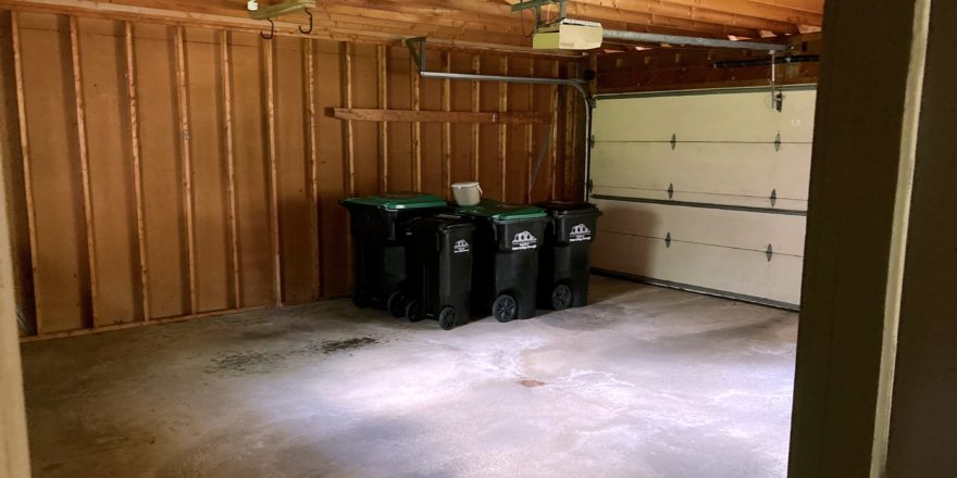 Garage with garbage and recycling bins