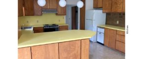 Kitchen with yellow countertops, wood-tone cabinets and appliances