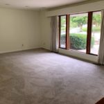 Carpeted living room with large picture window