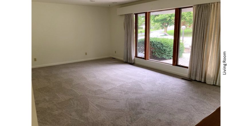 Carpeted living room with large picture window