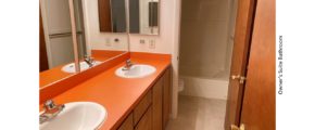 Bathroom with double vanity, toilet, and tub/shower combo