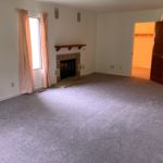 Owner's suite bedroom with gas fireplace and large windows