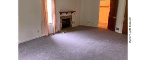 Owner's suite bedroom with gas fireplace and large windows