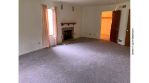 Owner's suite bedroom with gas fireplace and large windows