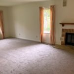 Owner's suite bedroom with gas fireplace and large windows