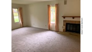 Owner's suite bedroom with gas fireplace and large windows