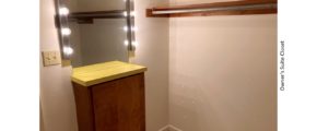 Owner's suite closet with small counter top and mirror with lighting