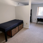 Bedroom with twin-size bed, bunk bed, desk with chair, and small dressers