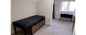 Bedroom with twin-size bed, bunk bed, desk with chair, and small dressers