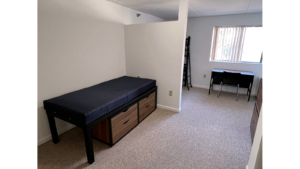 Bedroom with twin-size bed, bunk bed, desk with chair, and small dressers