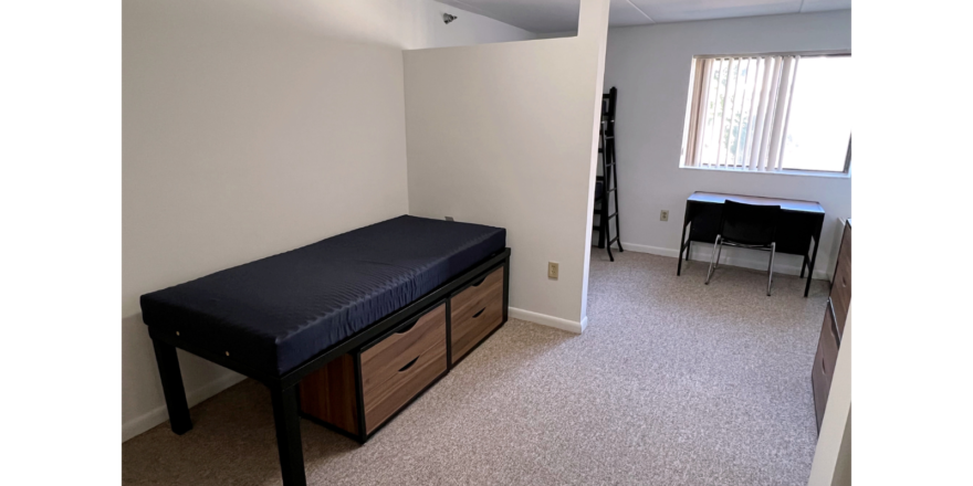 Bedroom with twin-size bed, bunk bed, desk with chair, and small dressers
