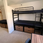 Bedroom with twin-size bed, bunk bed, desk with chair, and small dressers