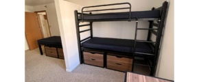 Bedroom with twin-size bed, bunk bed, desk with chair, and small dressers