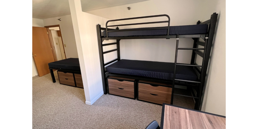 Bedroom with twin-size bed, bunk bed, desk with chair, and small dressers