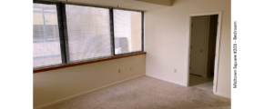 Unfurnished, carpeted bedroom with large windows