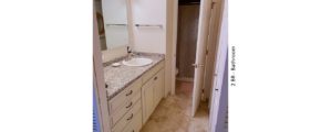 Bathroom with ceramic tile flooring, large vanity, and mirror