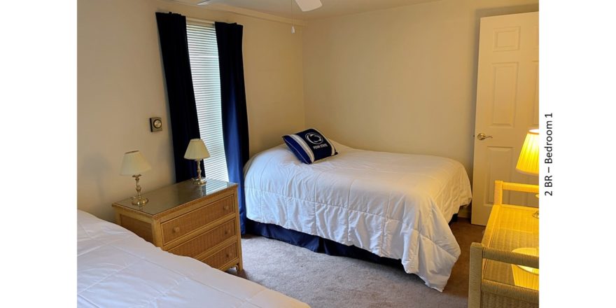 Bedroom with beds, dressers, lamps, ceiling fan, blinds, and curtains