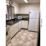 Kitchen with white cabinets and white appliances