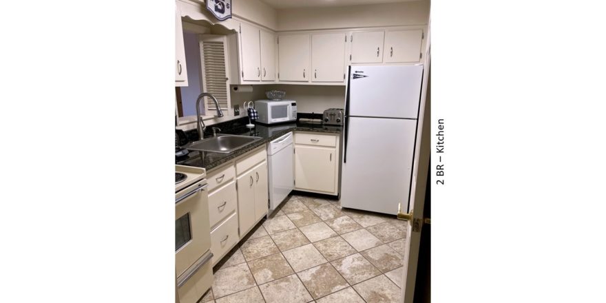 Kitchen with white cabinets and white appliances