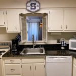 Kitchen with white cabinets and white appliances