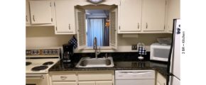 Kitchen with white cabinets and white appliances